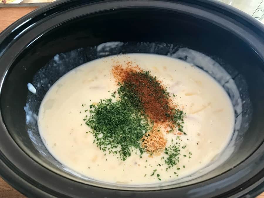 Slow cooker mac and cheese - adding the herbs and spices