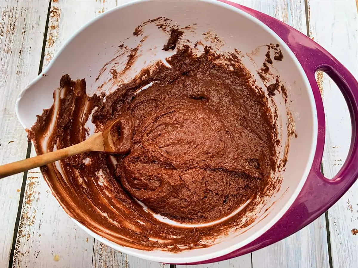 Chocolate cake mixture in mixing bowl after mixing well.