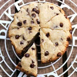 Large round scone with chocolate chips cut into triangles.