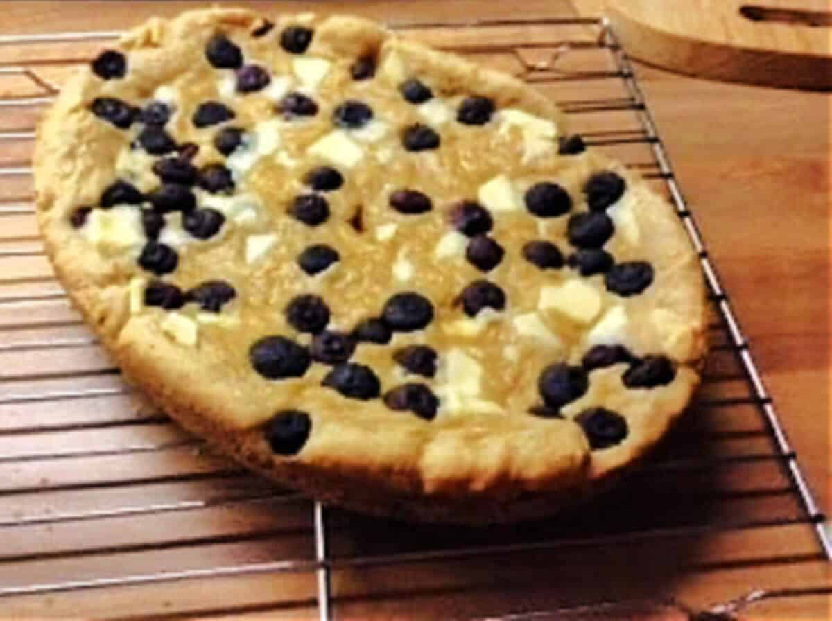 Giant cookie on a cooling rack.