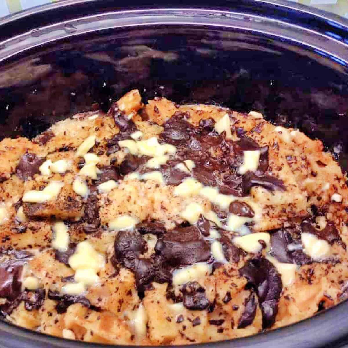 Chocolate pudding with baked waffles in slow cooker pot.