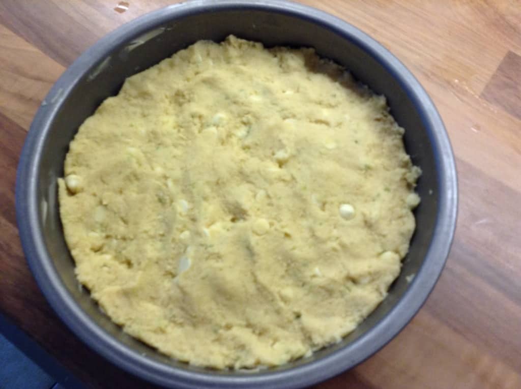 Shortbread dough in round cake tin.