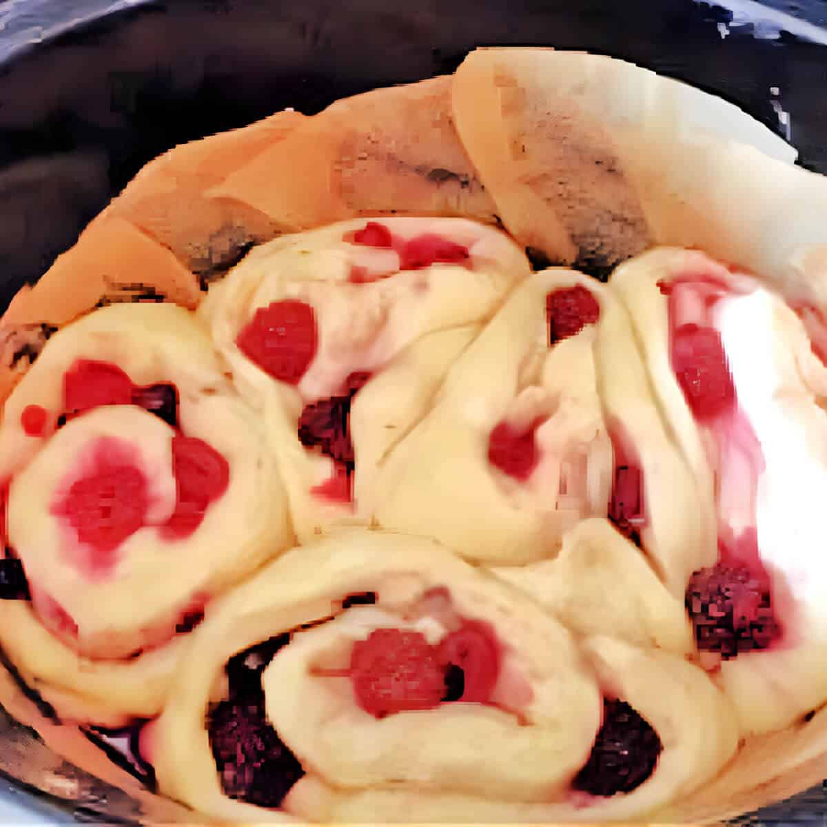 Berry rolls in slow cooker pot before baking.