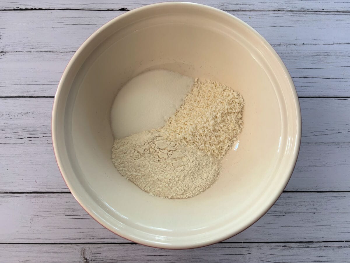 Flour, sugar, desiccated coconut in a large bowl.