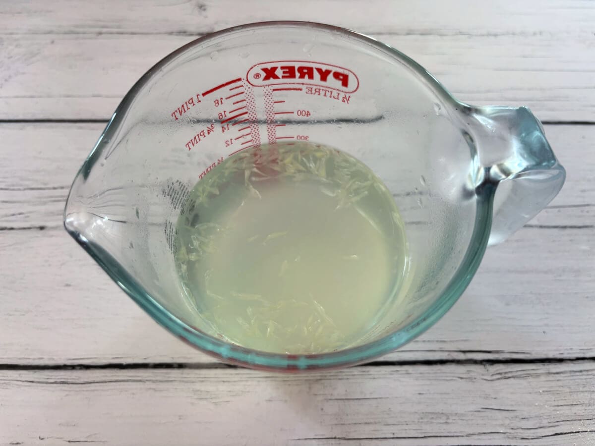 Lime juice, sugar and water in a jug.