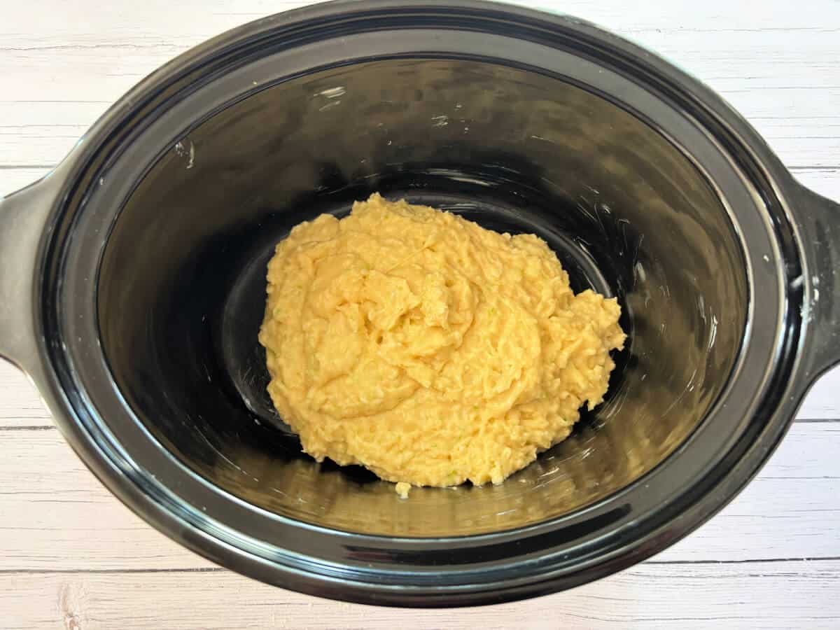 Cake mixture in slow cooker pot.