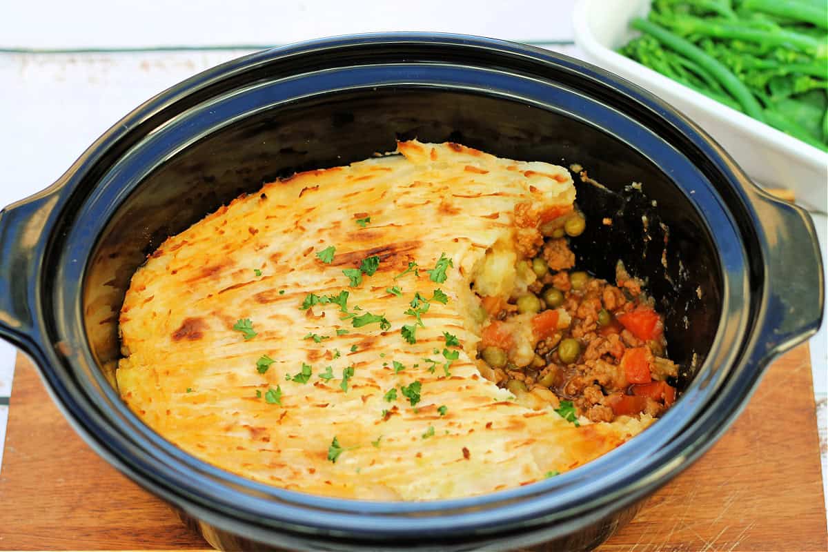 Shepherd's pie in slow cooker pot, a portion removed.