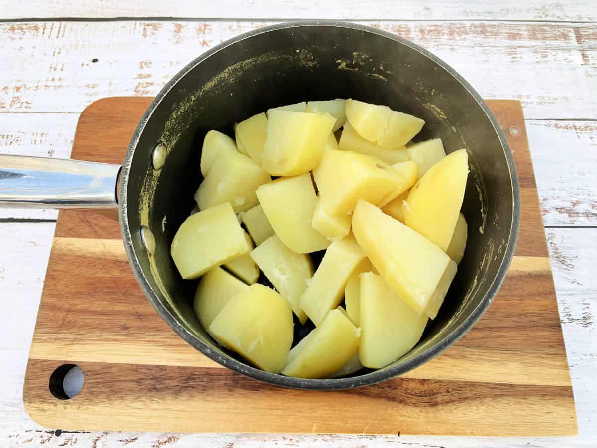 Cooked chopped potatoes in a pan.