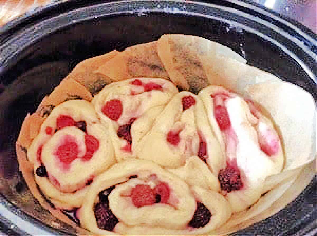 Berry rolls in slow cooker pot before baking.