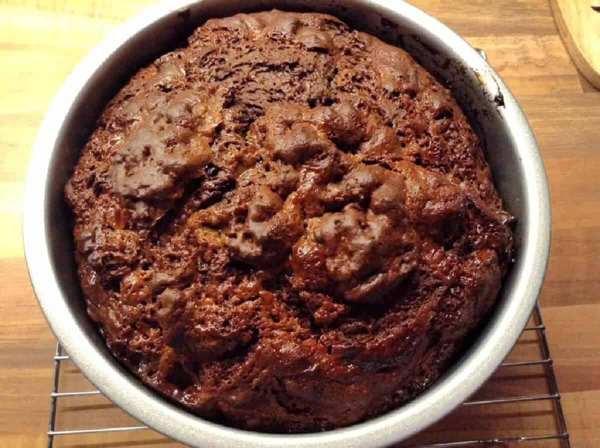 Caramel swirl and chocolate cake in cake tin.