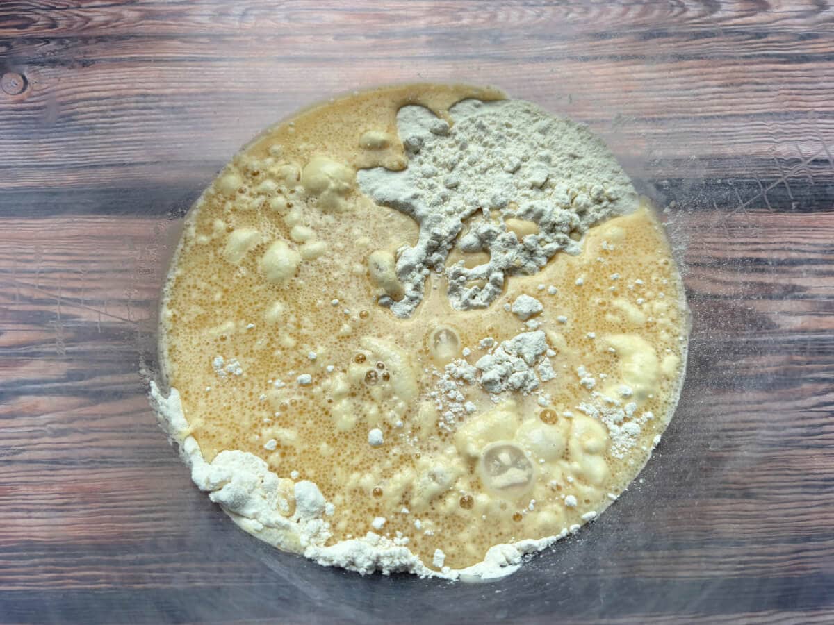 Cake batter mixture in a clear bowl.