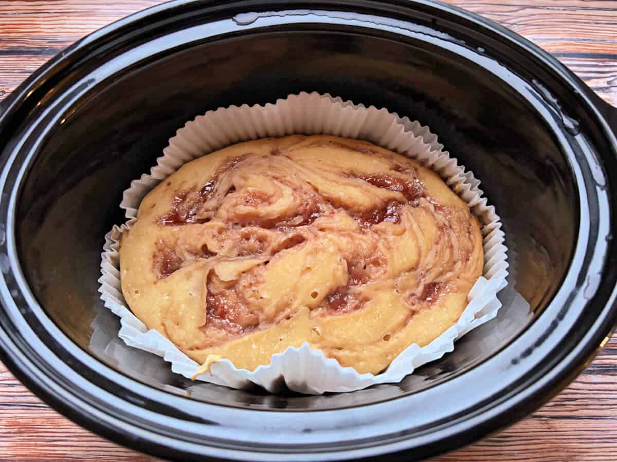 Baked cake in slow cooker pot.