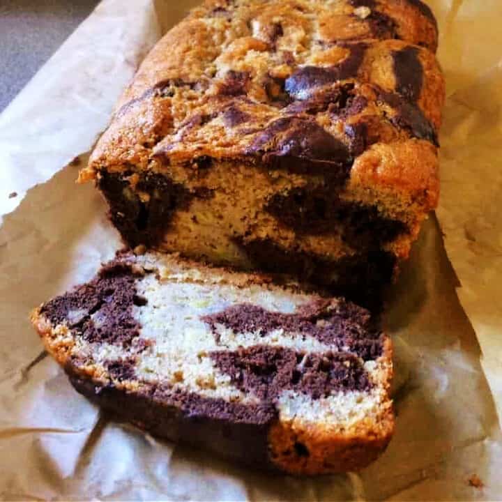 Banana bread cut open to show a marbled chocolate interior.
