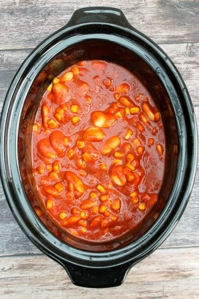 Overhead view of crockpot filled with red sauce.