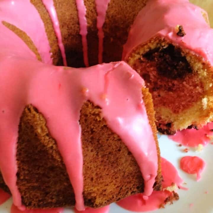 Neapolitan coloured bundt cake with pink icing.