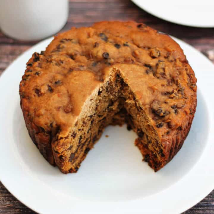 Tea loaf cake on a white plate, a slice cut out.