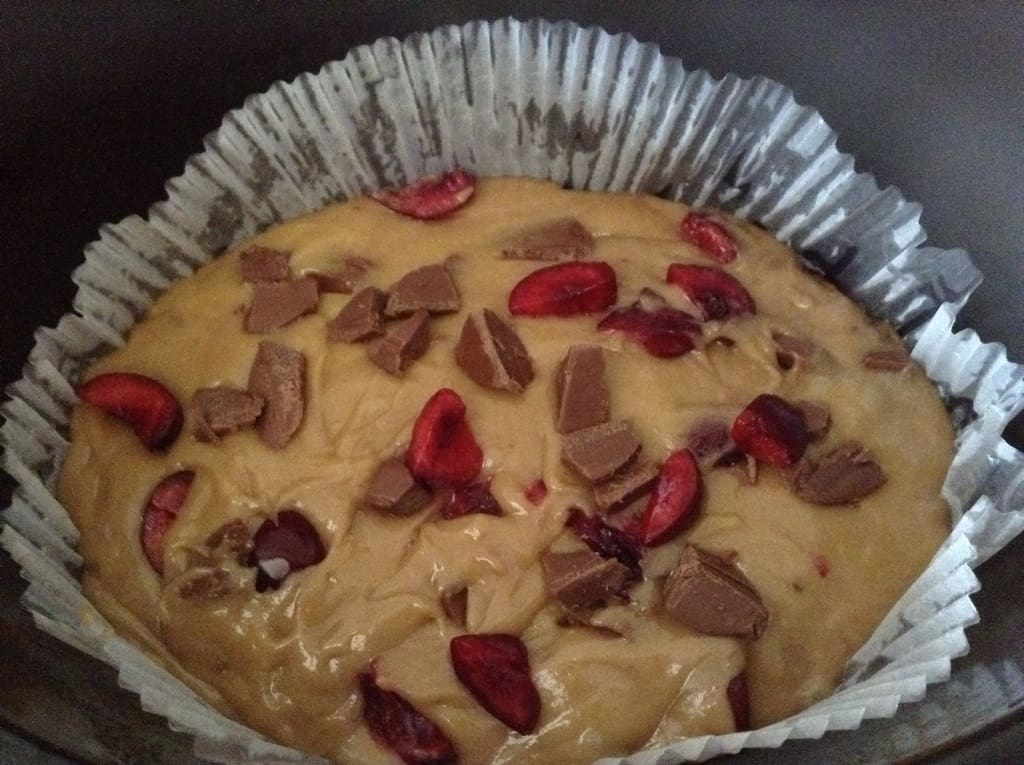 Blondie mixture with chocolate and cherries, in slow cooker pot.