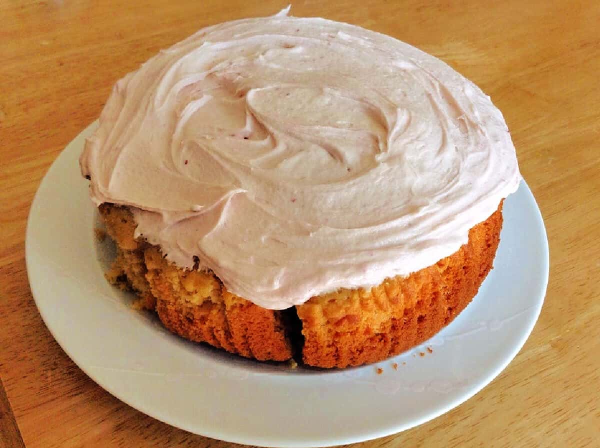 Cake with buttercream icing on a white plate.