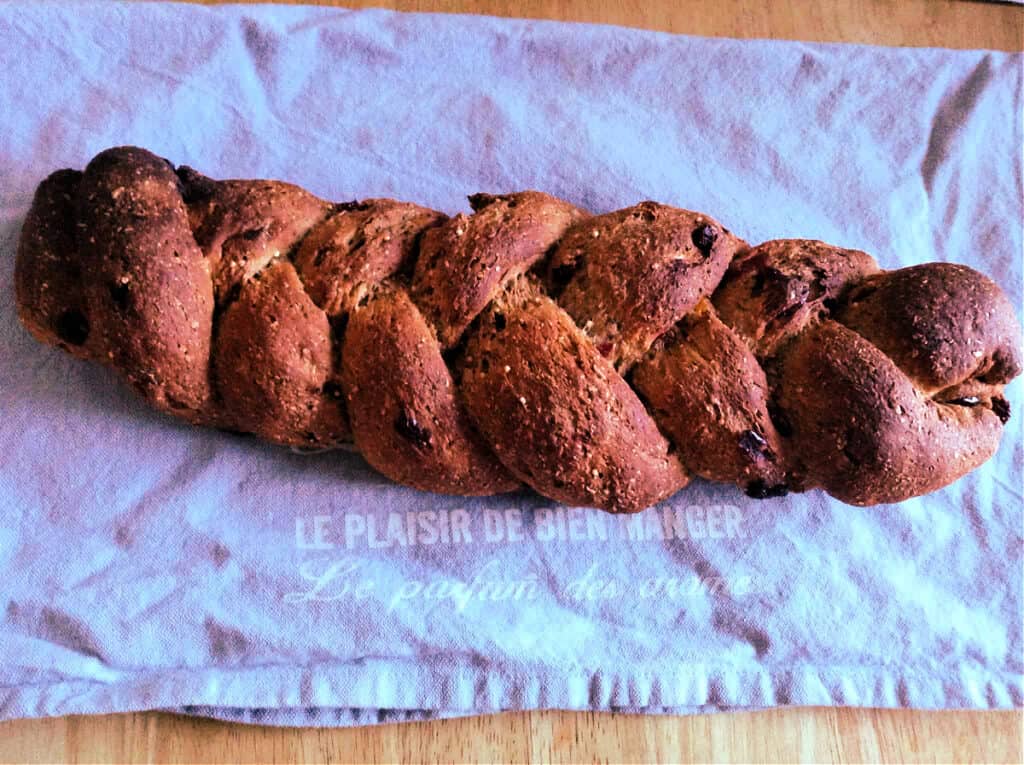 Braided loaf on a grey cloth, after baking.