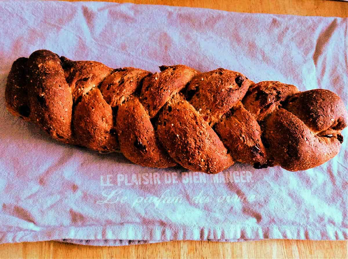 Braided loaf on a grey cloth, after baking.