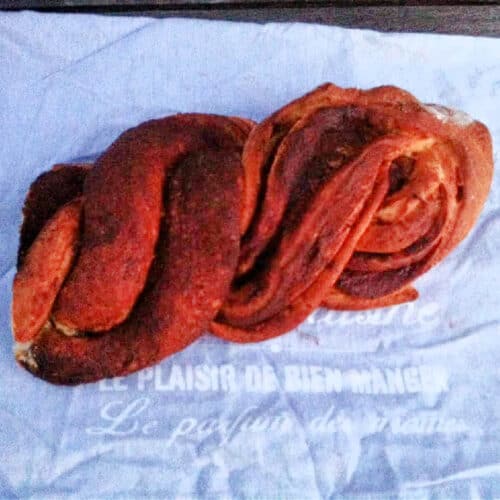 Twisted chocolate braided bread on grey cloth.