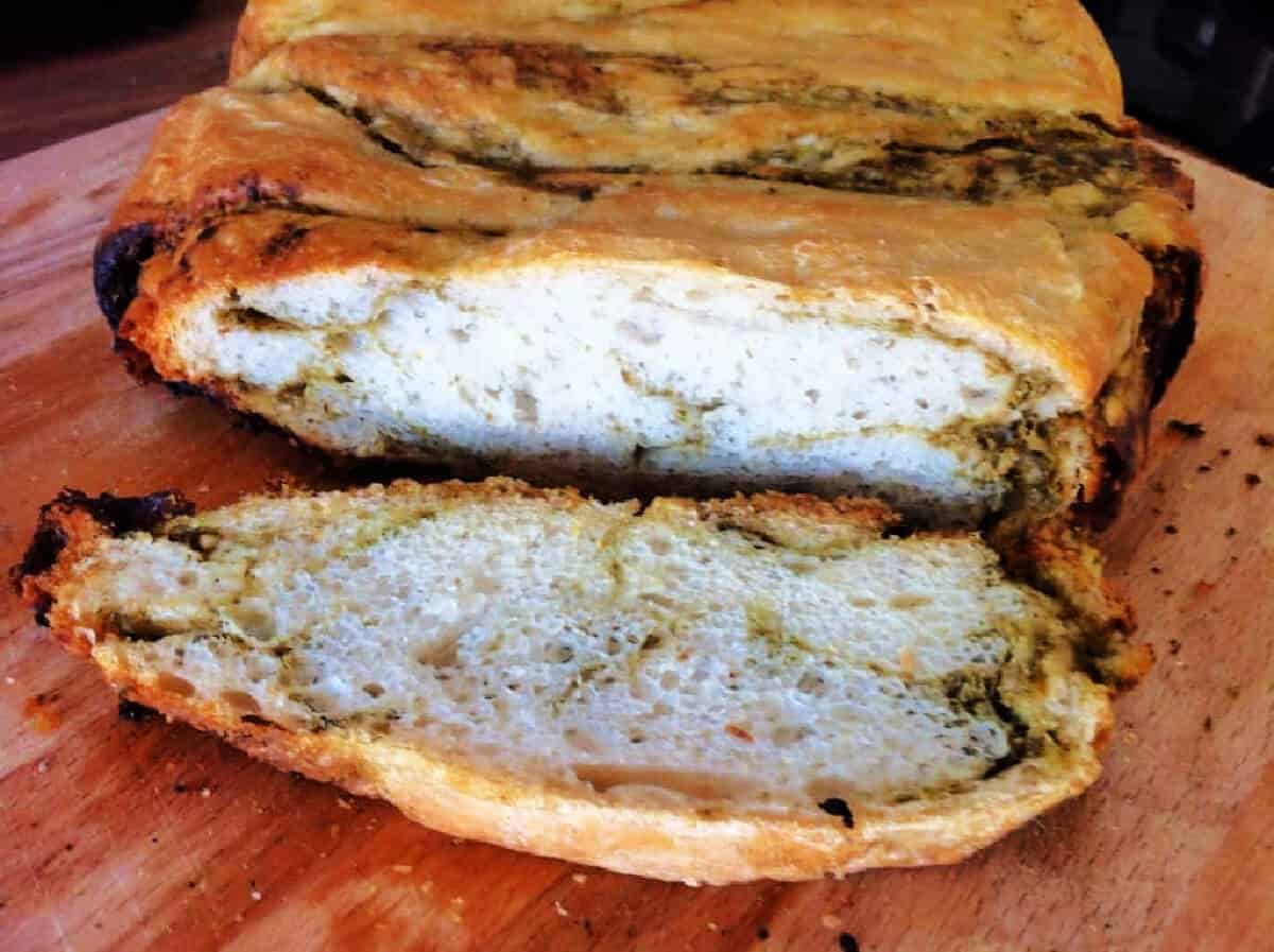 Bread rippled with pesto, cut open to show the interior of the loaf.