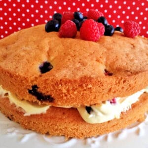 Berry cake with berries on top and cream filling.