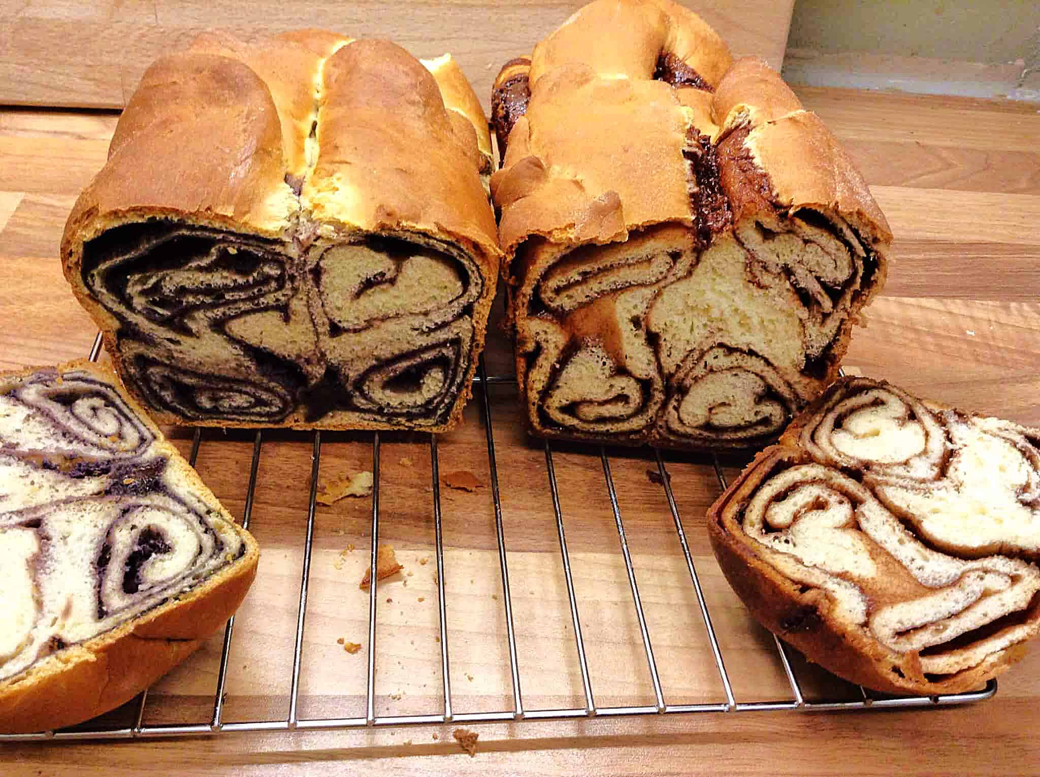Two Povitica loaves cut open on a cooling rack.