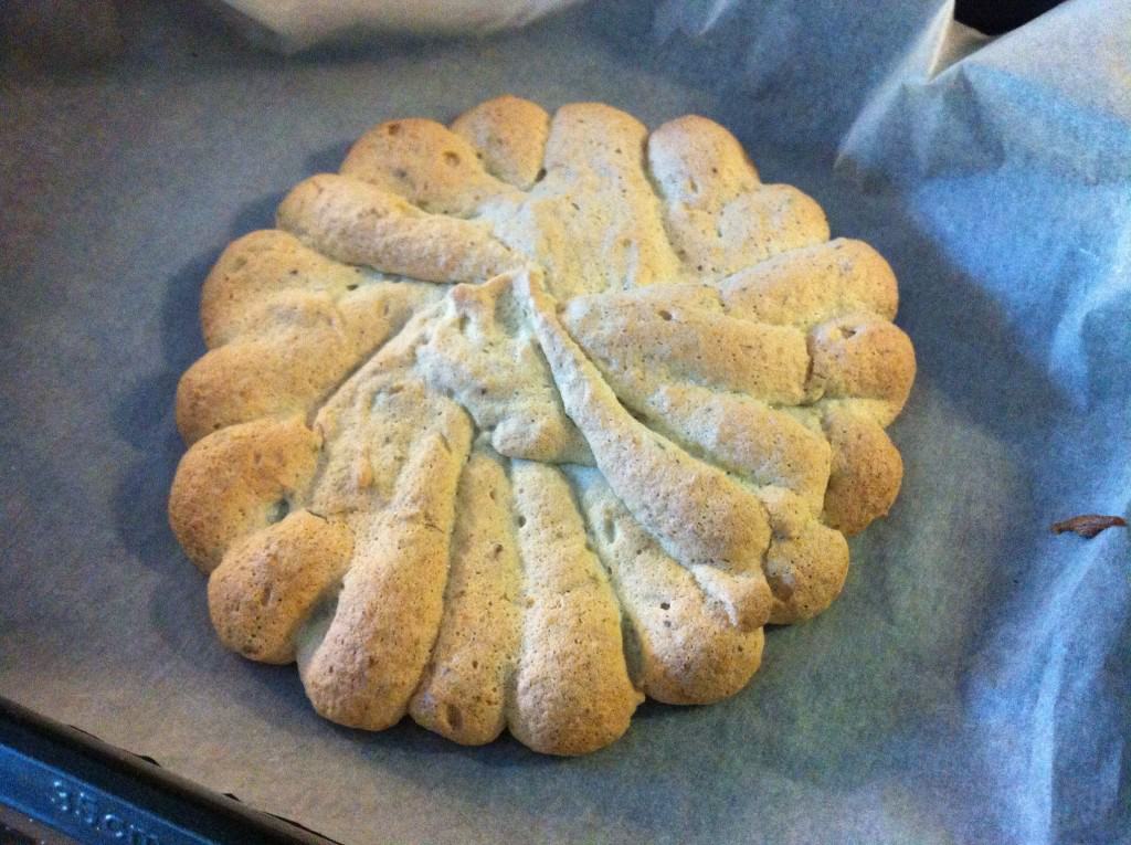 Baked dacquoise on lined baking tray.