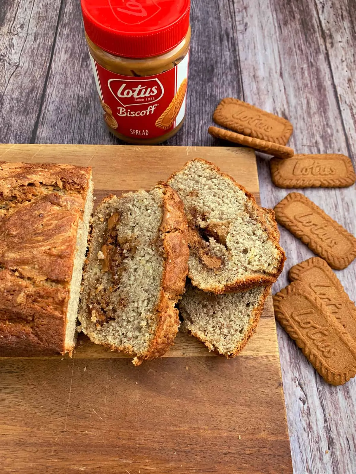Banana bread with Biscoff spread inside and Biscoff spread and biscuits to the side.