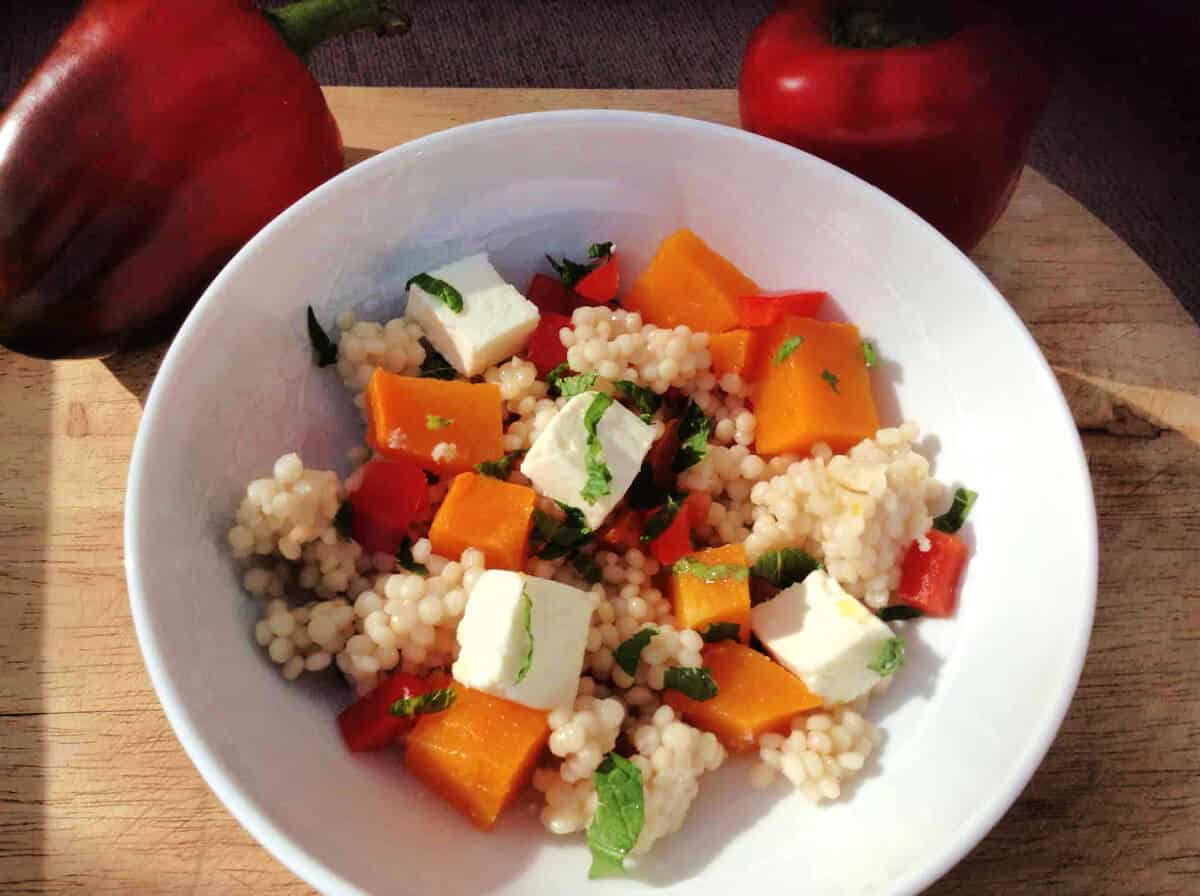 White bowl of butternut and feta salad.