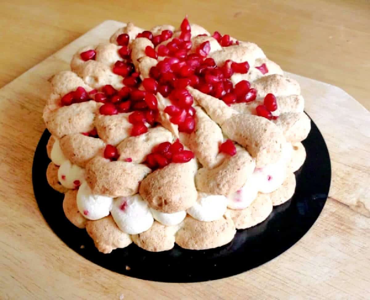 Decorated Pistachio Dacquoise dessert with cream filling.