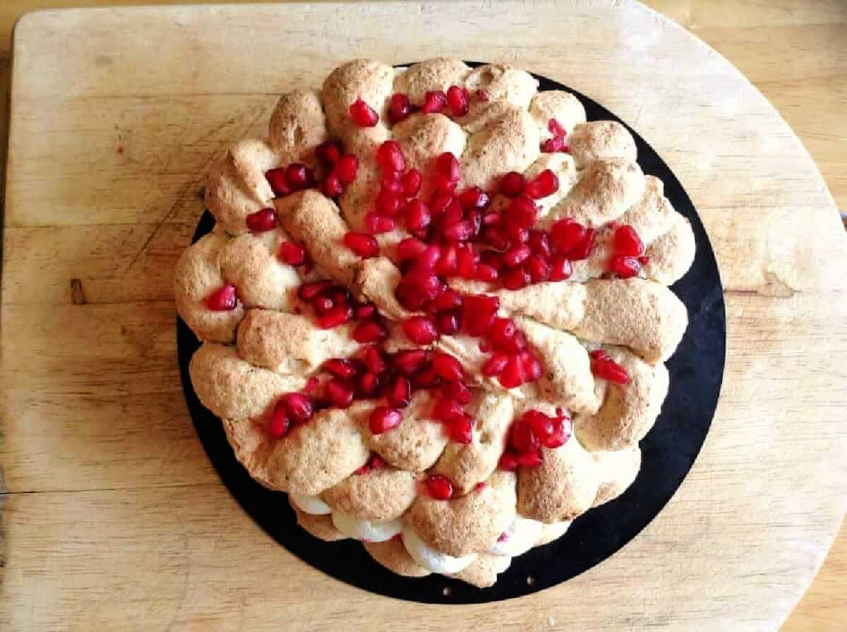 Decorated Pistachio Dacquoise dessert with cream filling.