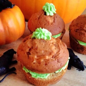Halloween orange-coloured pumpkin cupcakes with green icing.