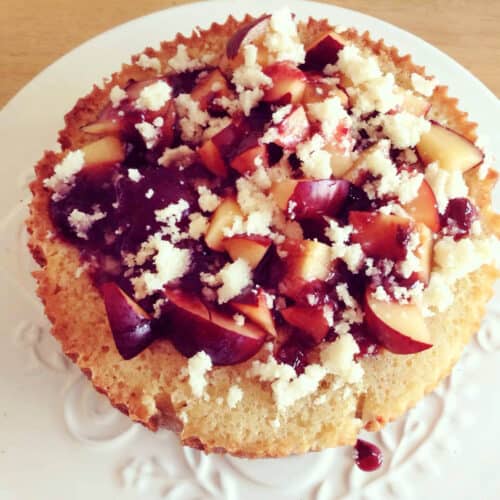 Plum cake topped with plums and jam.