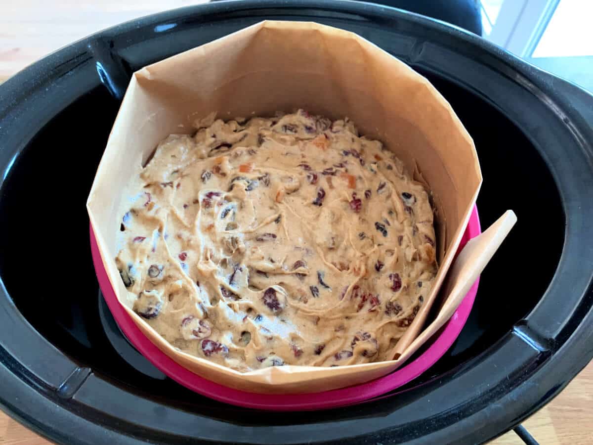Christmas Cake in lined silicone pan in slow cooker, before baking.