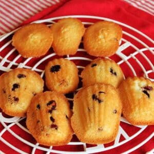 Cranberry madeleines on a round cooling tray.