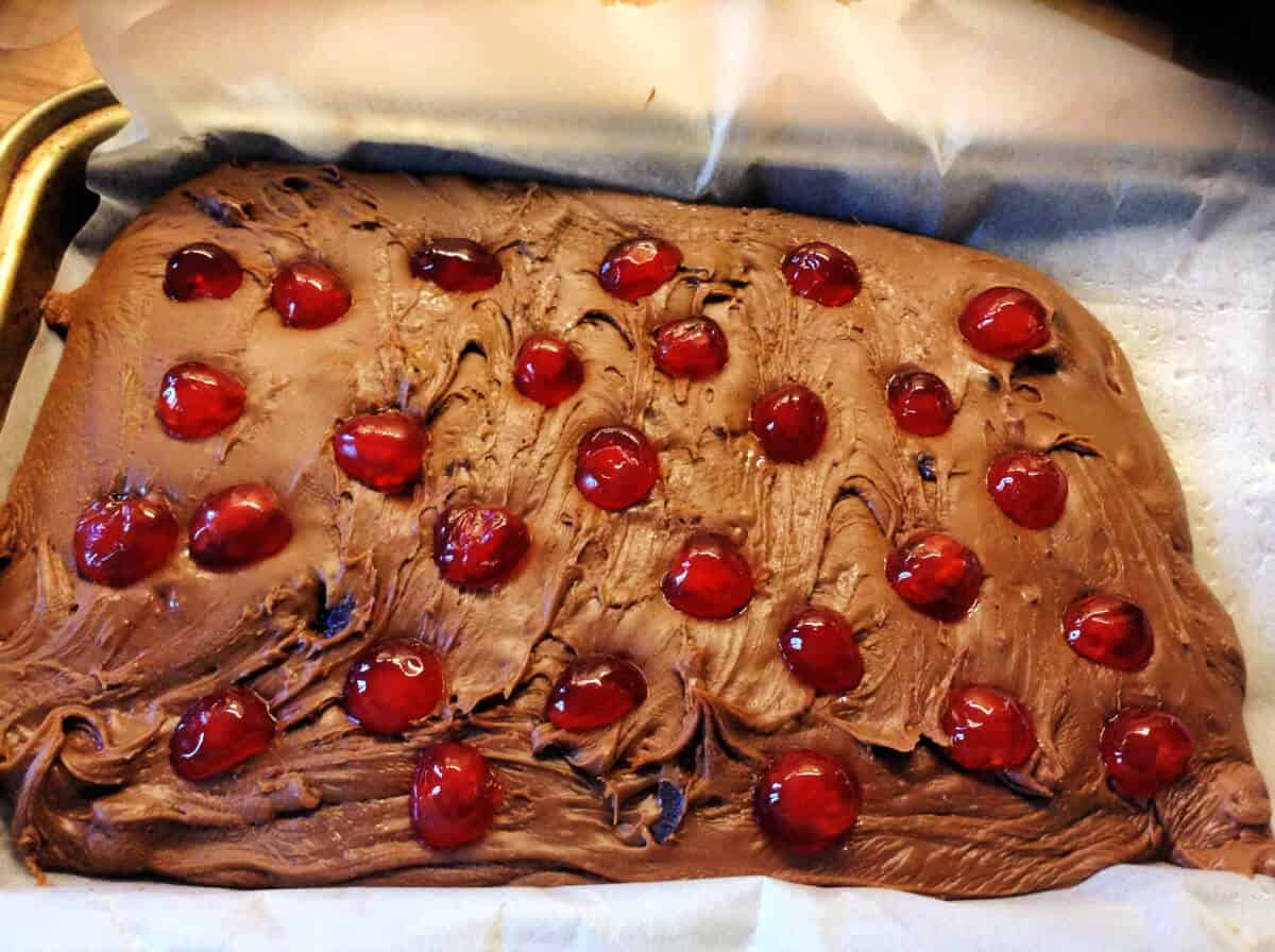 Large slab of chocolate fudge studded with candied cherries.