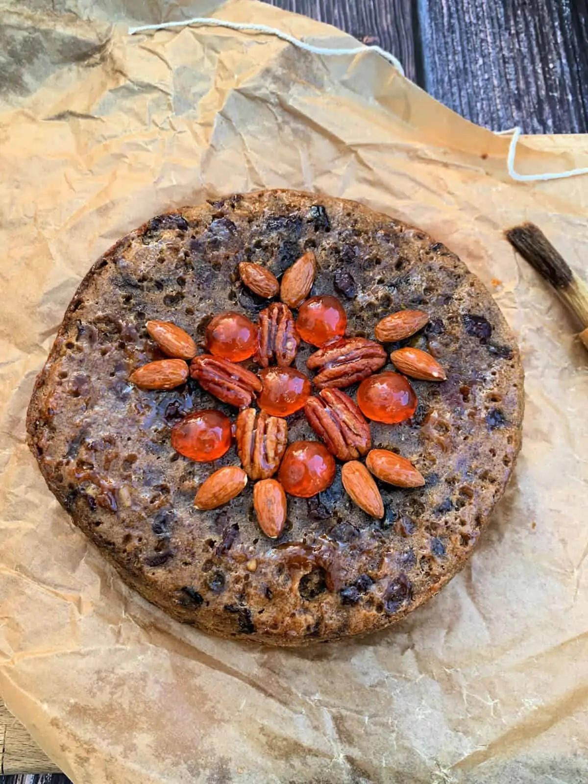 Decorating a fruit cake with nuts.