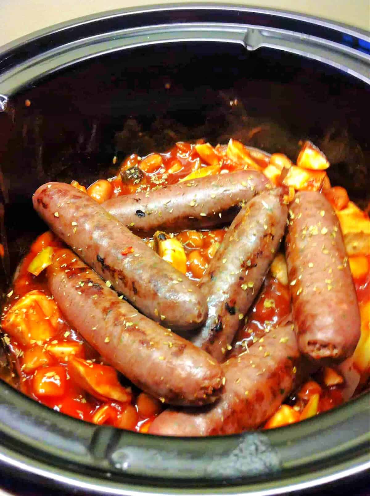 A slow cooker pot with venison sausage casserole.