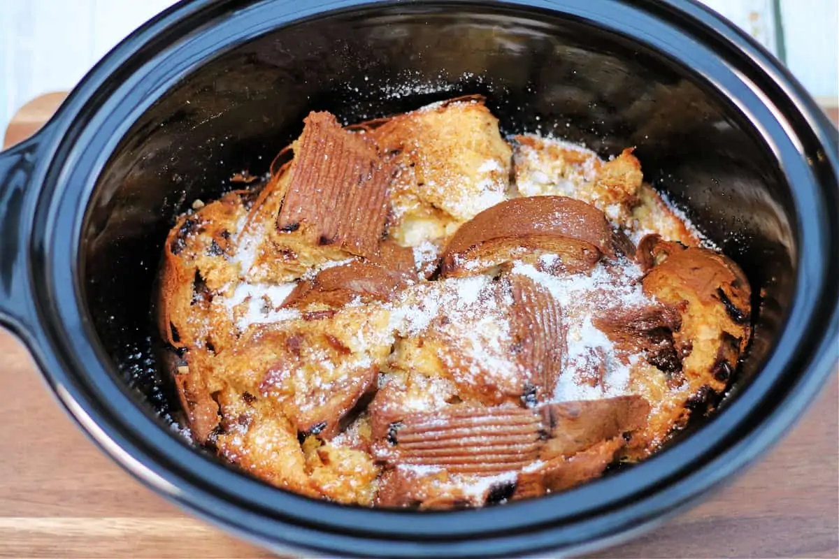 Baked panettone pudding in slow cooker pot, ready to serve.