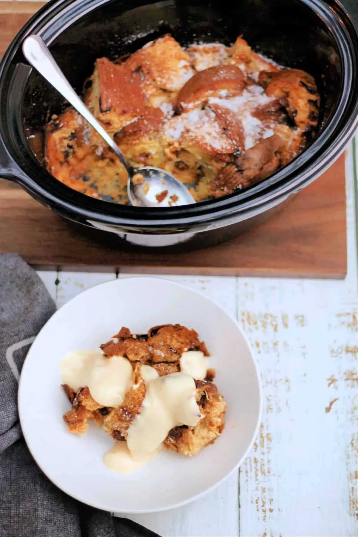 Bowl of panettone French toast with custard, next to serving dish.