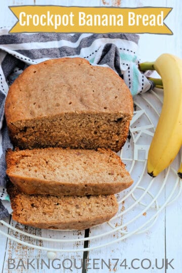 Sliced banana loaf on a rack, with a banana to the side, with text overlay (crockpot banana bread).