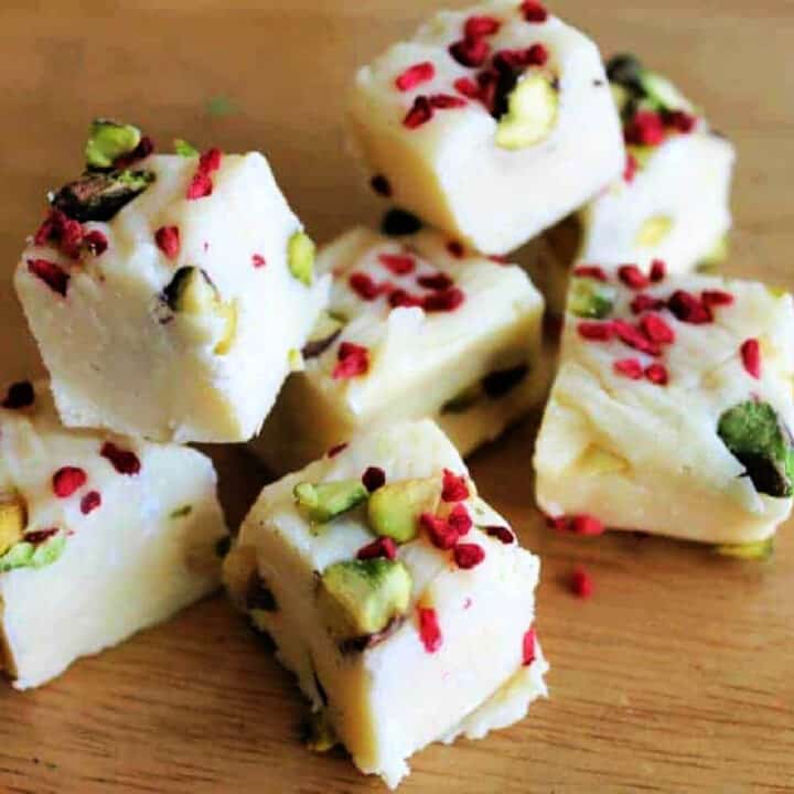 Squares of white chocolate fudge decorated with pistachio and raspberry pieces.
