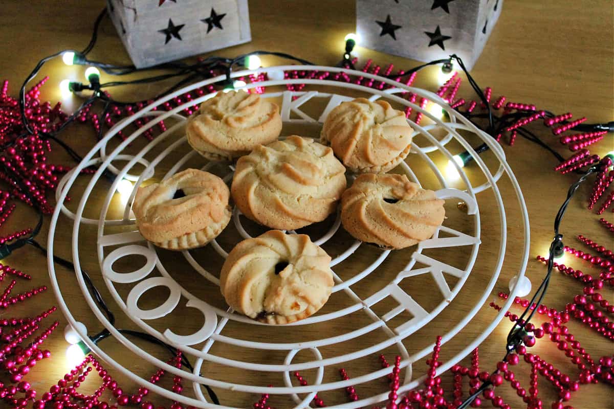 Mince pies on a cooling rack.