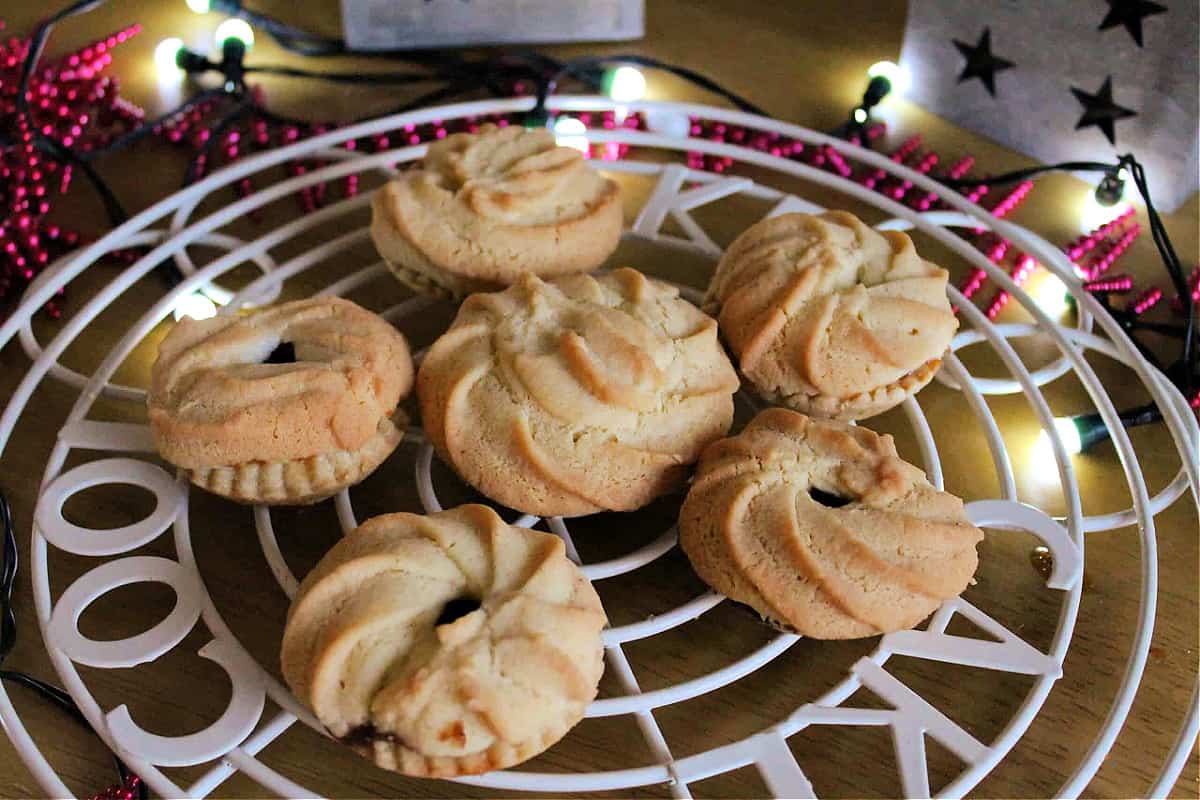 Mince pies on a cooling rack.