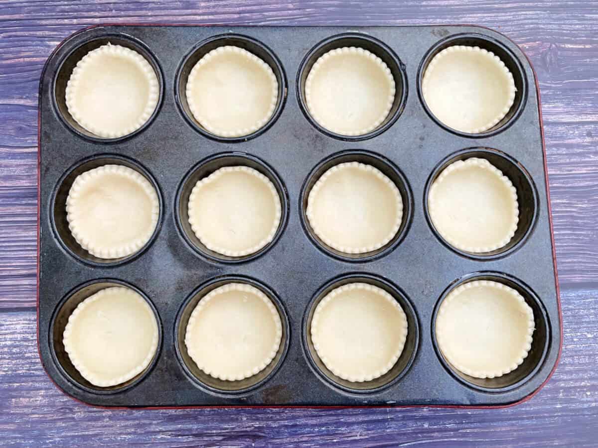 Mince pie tins lined with pastry.