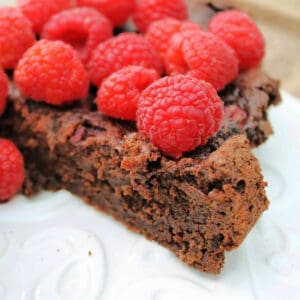 Raspberry brownies topped with fresh raspberries.