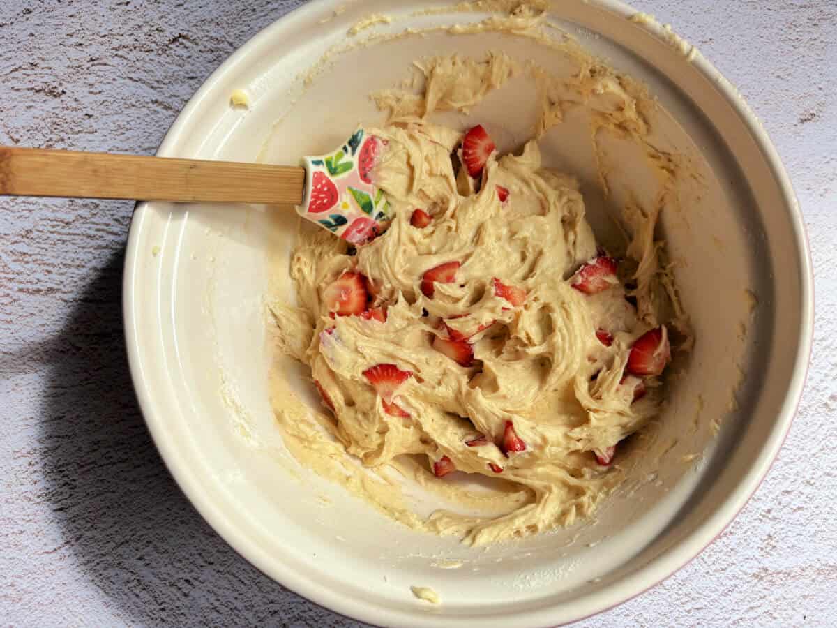 Cake mixture with chopped strawberries mixed in.
