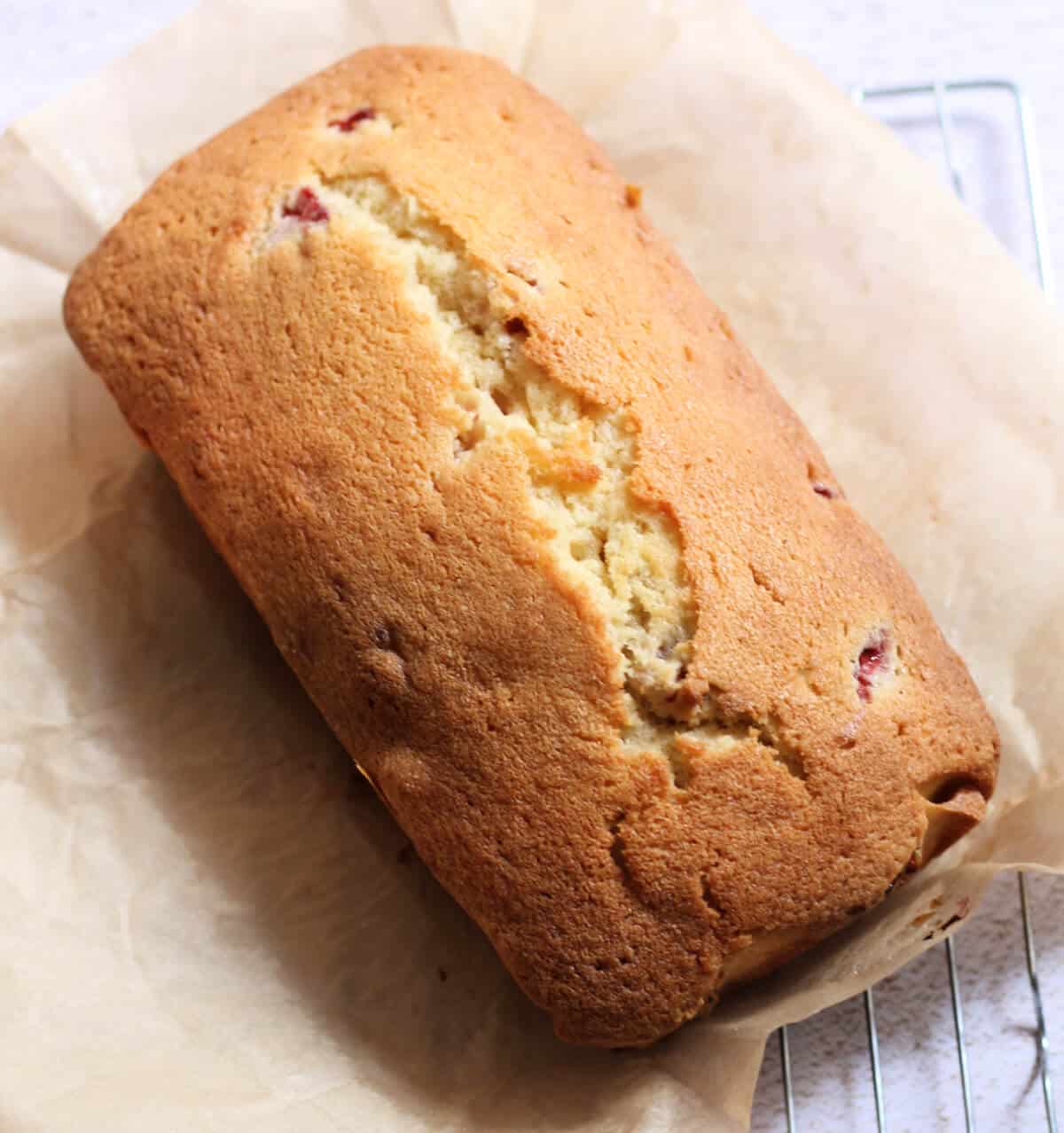 Baked loaf cake on baking paper.